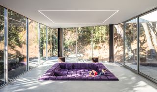 minimalist living room with purple sunken seating