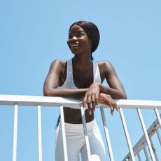 How to add variety to your walks: A woman leaning against a railing