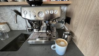 Breville Barista Express Impress next to espresso