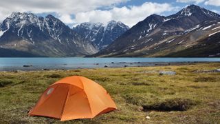 A tent pitched near a mountain lake