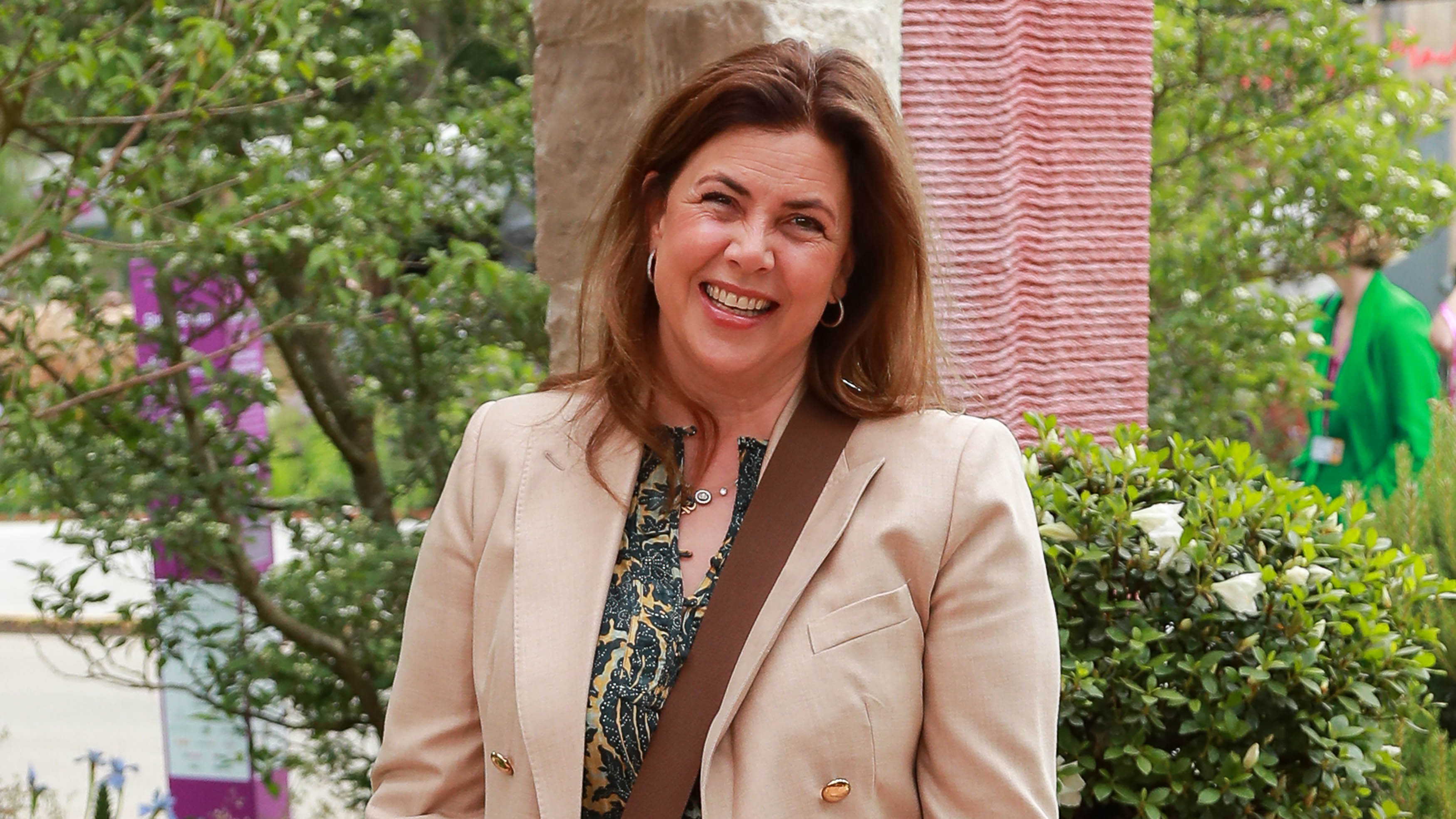 Kirstie Allsop wearing a floral dress and beige blazer