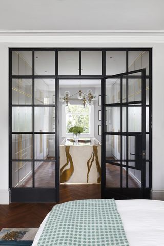 bedroom with Crittall-style doors leading through to a dressing room