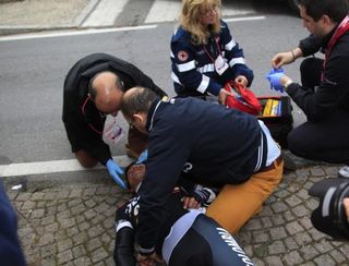 Carlos Quintero (Colombia-Coldeportes) is attended by RCS Sport paramedics and team doctor Massimiliano Mantovani after his crash on the descent of La Manie.