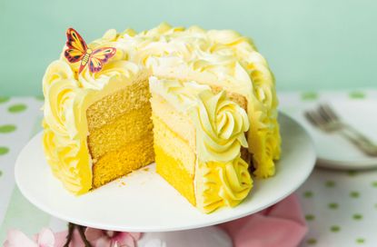 lemon ombre cake on a white cake stand