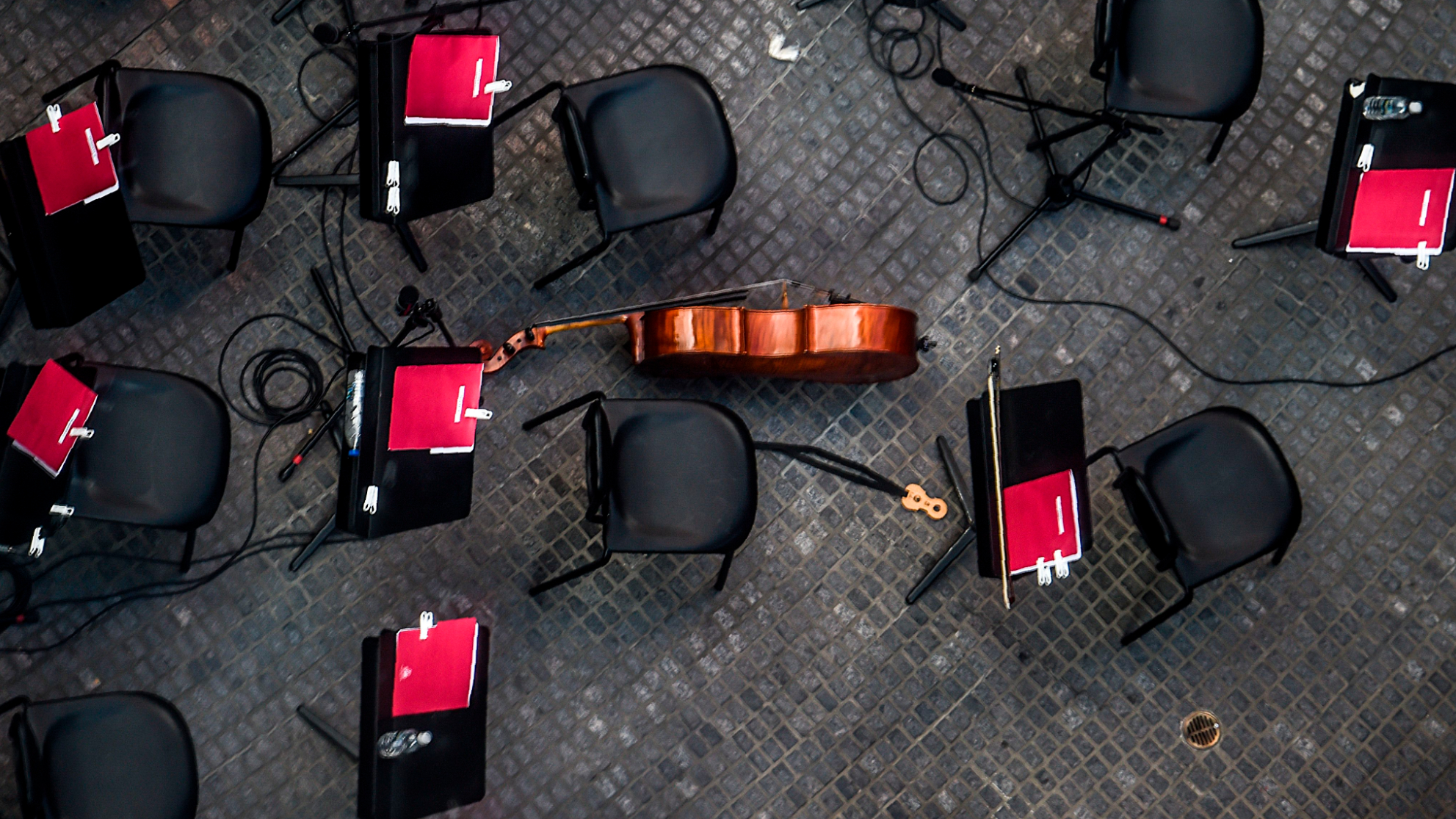 An orchestra instrument lays on the ground surrounded by empty chairs during a concert recess in Caracas on December 20, 2017