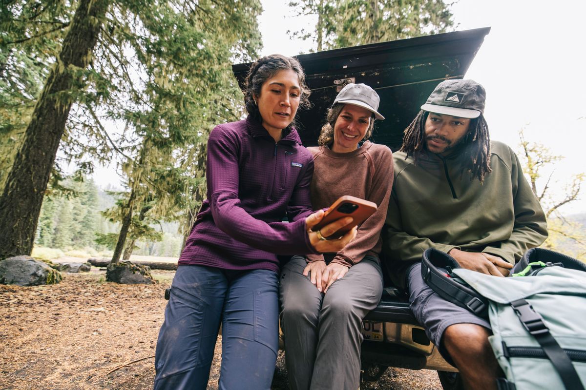 People hiking and using the AllTrails app