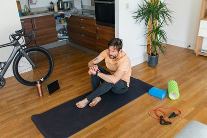 Image shows a rider completing a home workout to stay injury free 