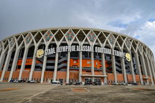 This photograph taken in Ebimpe northern Abidjan on December 5, 2023 shows a general view of the entrance of the Alassane Ouattara Olympic stadium, one of the six stadiums for the CAN 2024 during a visit to the CAN infrastructures by journalists from the international press. After concerns about its level of preparation, Ivory Coast has stepped up the pace for the African Cup of Nations (CAN), which is set to start on January 13, 2024. Having become a leading international competition with 24 qualified teams, the CAN could attract up to 1.5 million visitors, according to the organizers. (Photo by Sia KAMBOU / AFP) (Photo by SIA KAMBOU/AFP via Getty Images) AFCON 2023 stadiums