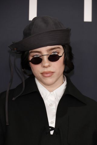 Billie Eilish wearing a sailor hat and sunglasses on the 2025 grammys red carpet