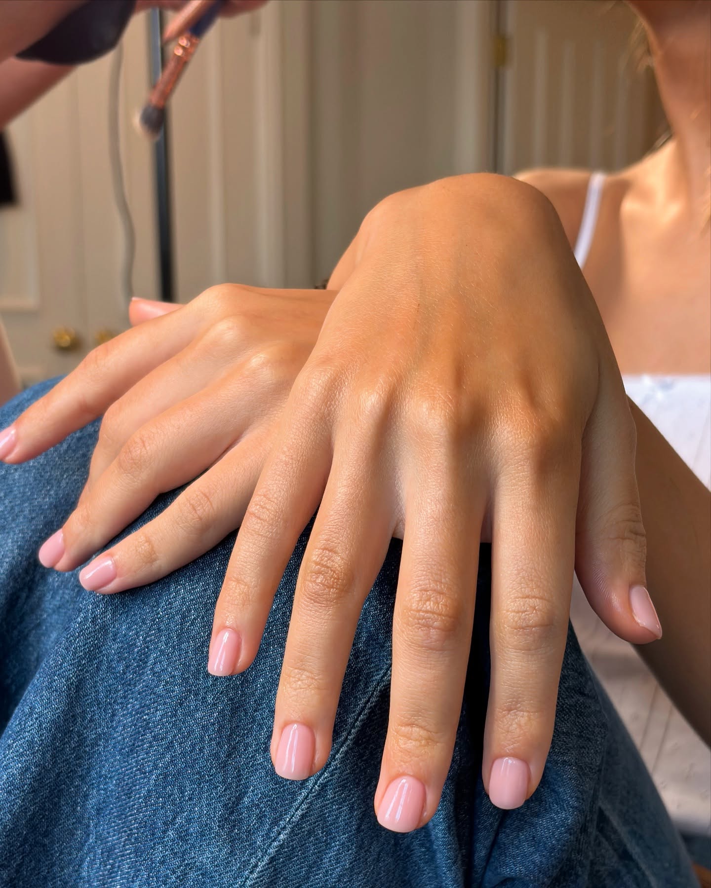 An image of @paintedbyjools wearing BIAB nails.