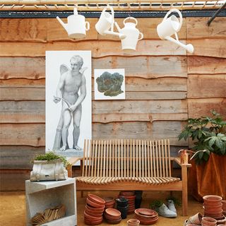 potting shed with edge with amaze sofa cupid after praxiteles artwork and cabbage print ceramic watering cans and chaussures concrete planters