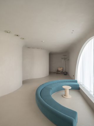 Lounge area of Soul Realm Spa House in Hangzhou, China with white curving walls