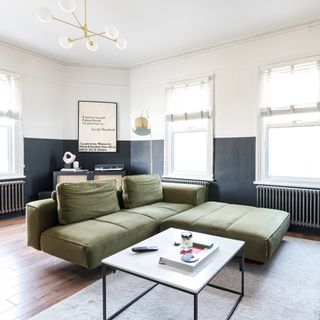 living room with green sofa and coffee table
