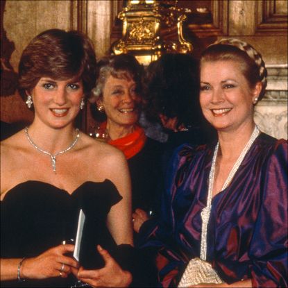 Princess Diana wears a strapless black taffeta Emanuel dress and poses next to Princess Grace Kelly of Monaco and King Charles on March 9, 1981 in London, United Kingdom