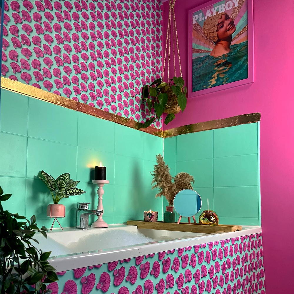 room with pink wall green foliage and wallpaper