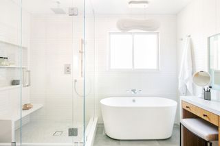 small white bathroom with subway tiles by LH Designs