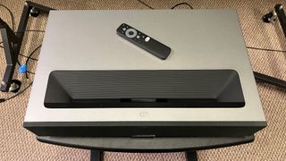 formovie theater projector from above with remote control on top