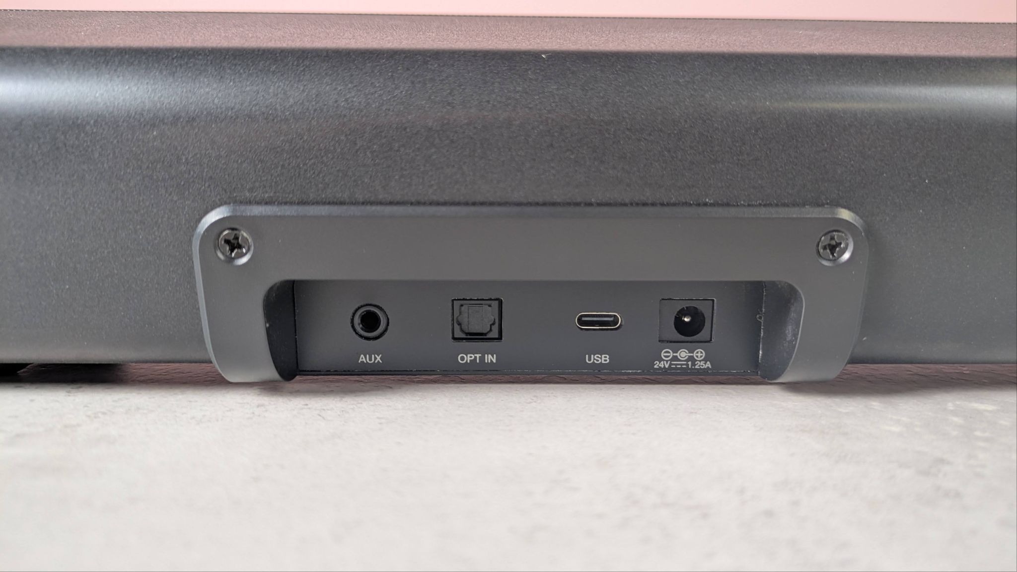 Creative Sound Blaster GS5 on a desk with pink wall in background