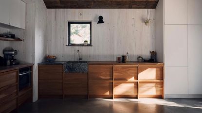 a japanese-inspired kitchen with butcher block countertops and a soapstone sink