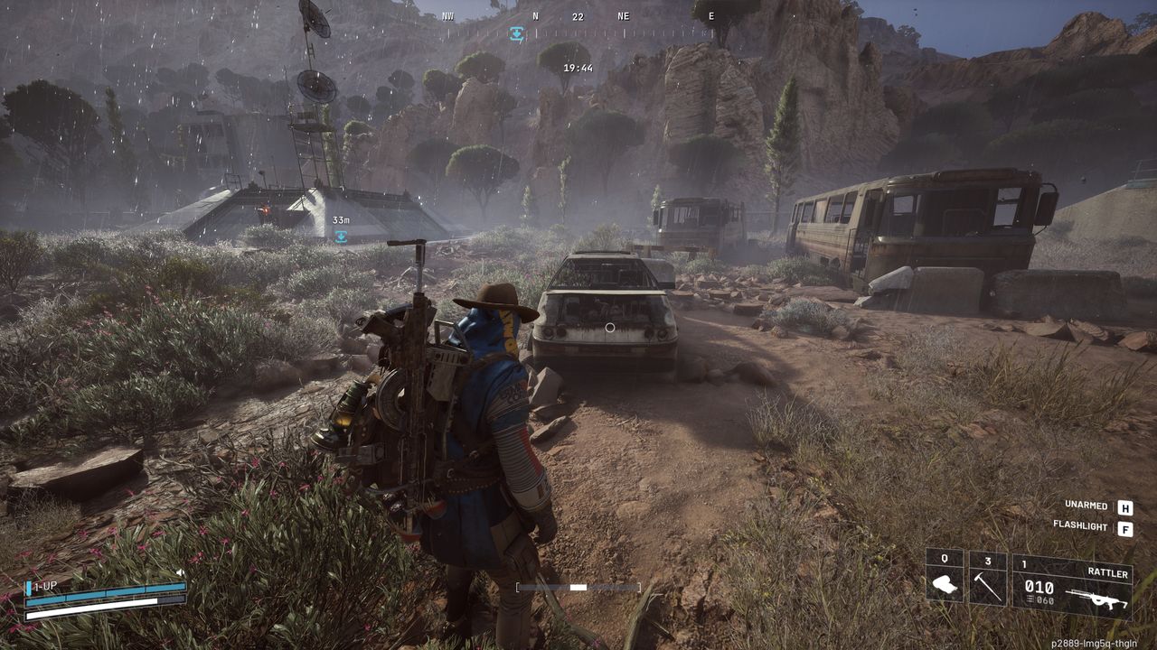 Arc Raiders light bulb locations: A player wearing a blue poncho and a cowboy hat looking at a rusted car in the rain near an extraction lift and two abandoned buses.