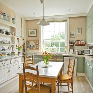 kitchen room with white kitchen shelves and wooden table with chairs