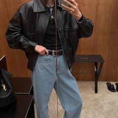 Influencer wearing a leather bomber jacket and jeans