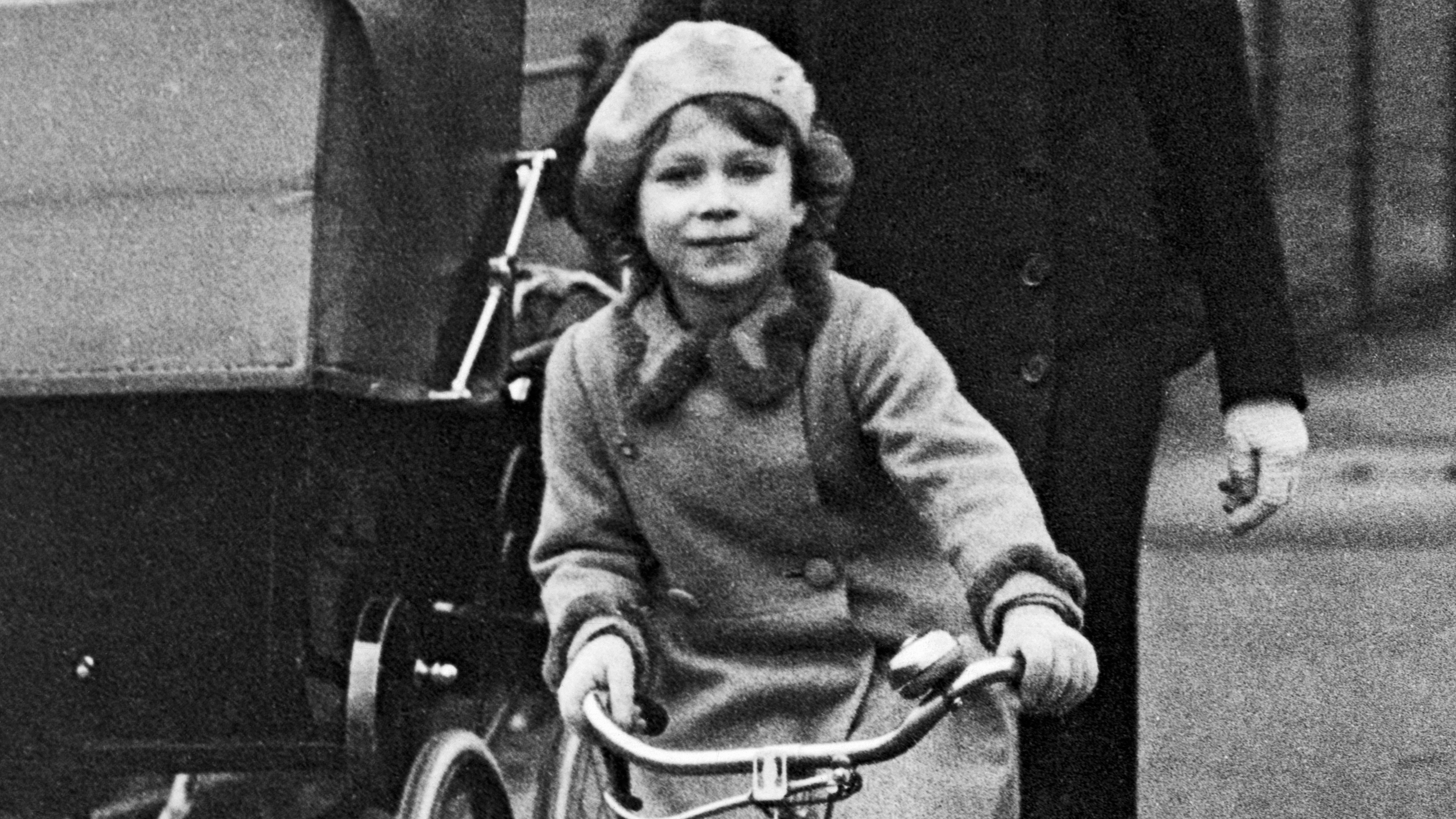 The young Princess Elizabeth riding her tricycle in the park