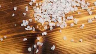 Scattering of rock salt on wooden table