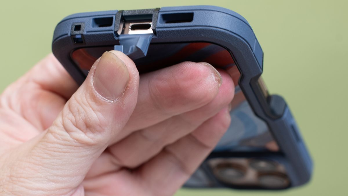 Otterbox Defender Series Pro XT from bottom showing USB-C port cover held open by fingers