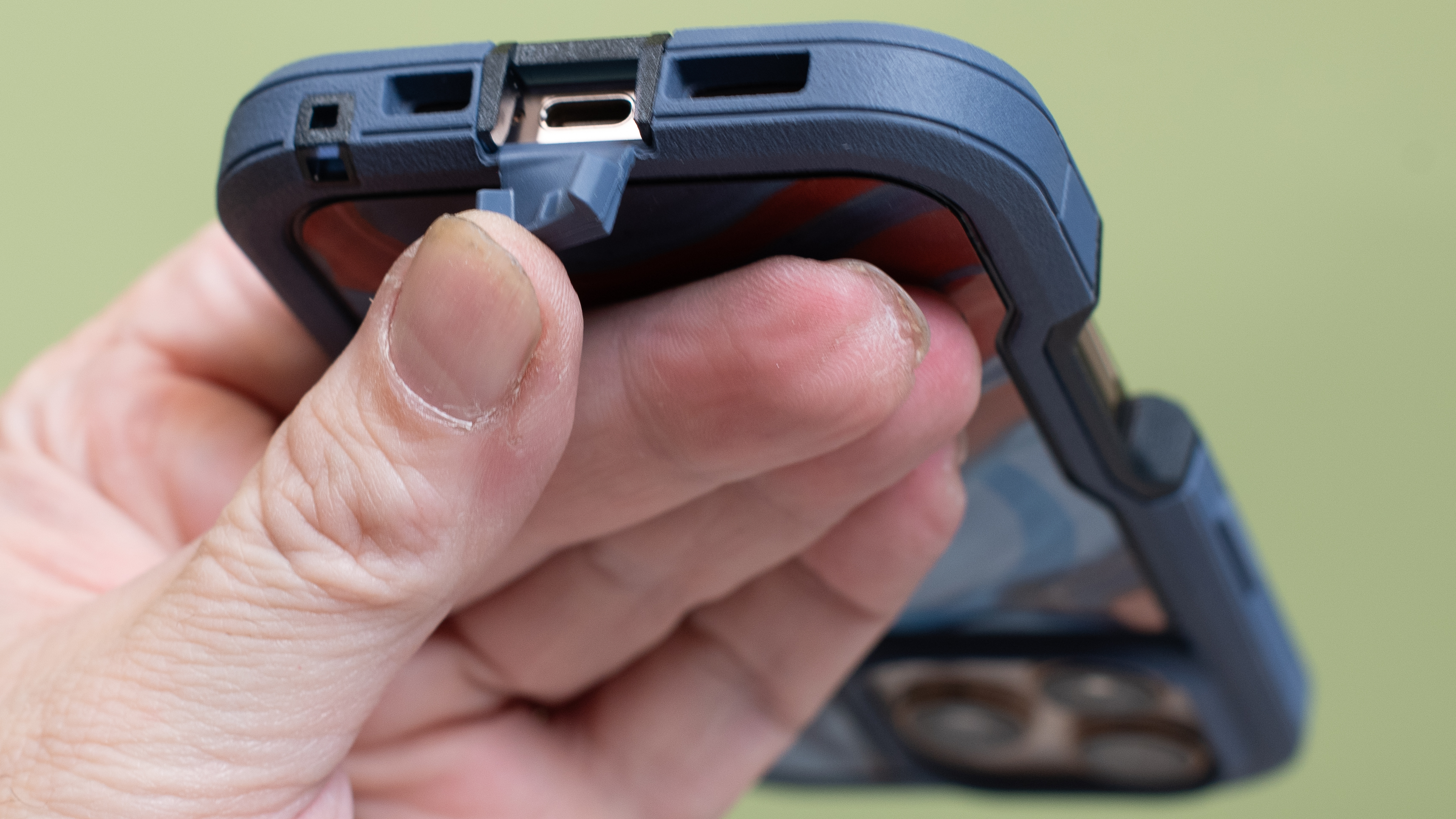 Otterbox Defender Series Pro XT from bottom showing USB-C port cover held open by fingers