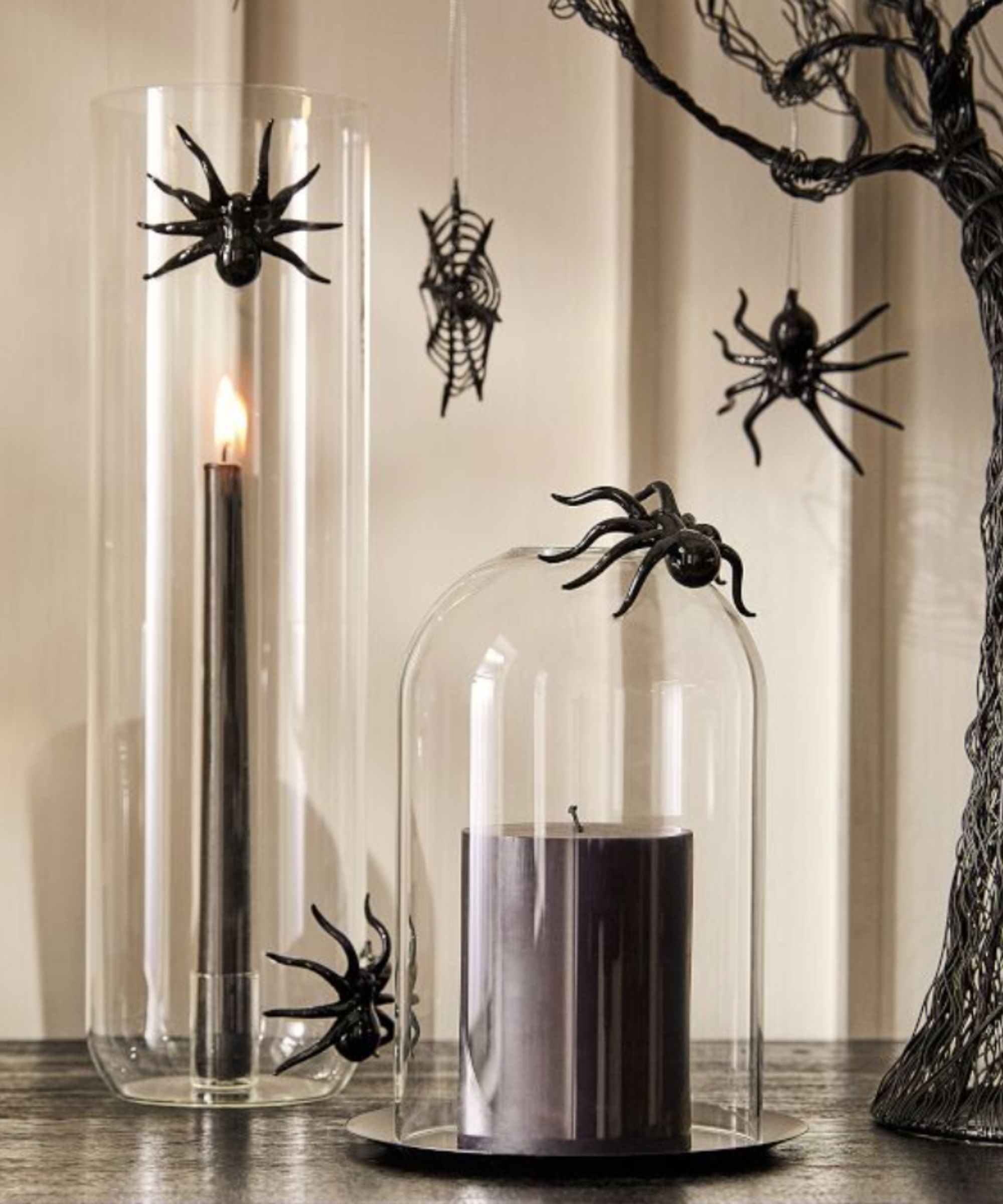 Glass spider candle holders with black pillar candles in