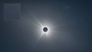 A photo of the sun during totality with the location of the comet highlighted