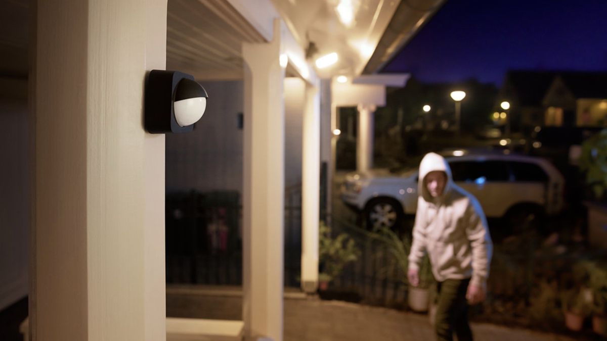 Philips Hue Outdoor Motion Sensor installed outdoors overlooking a home&#039;s entrance