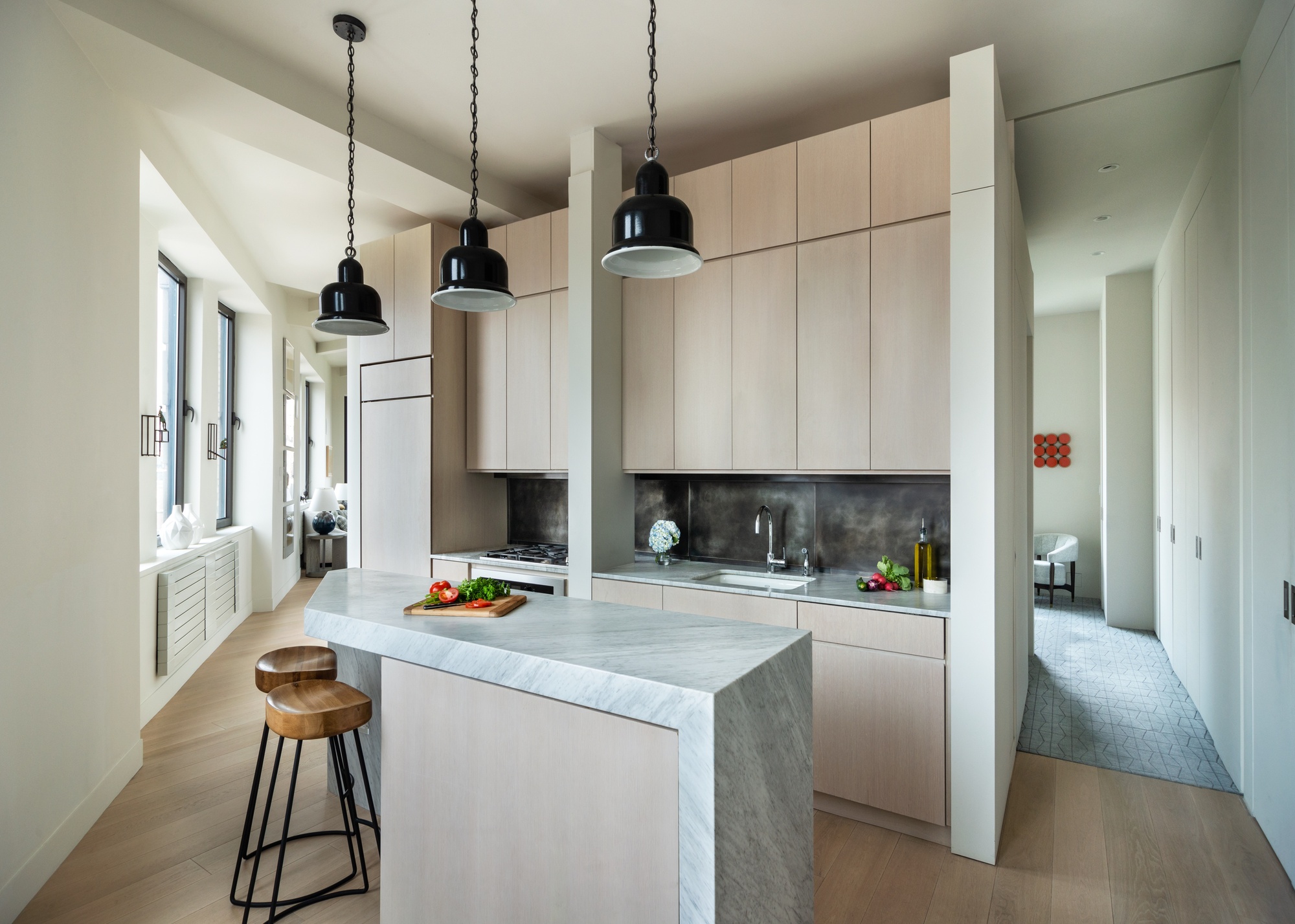 A small kitchen with an angular wall and a slim island