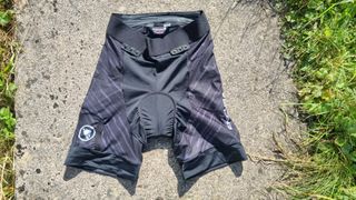 Shorts laid on ground outside, front side up showing inside waist