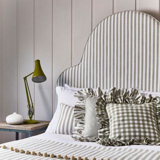 Striped headboard with frilled cushions