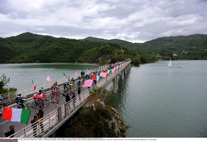 The Giro peloton crosses a bridge