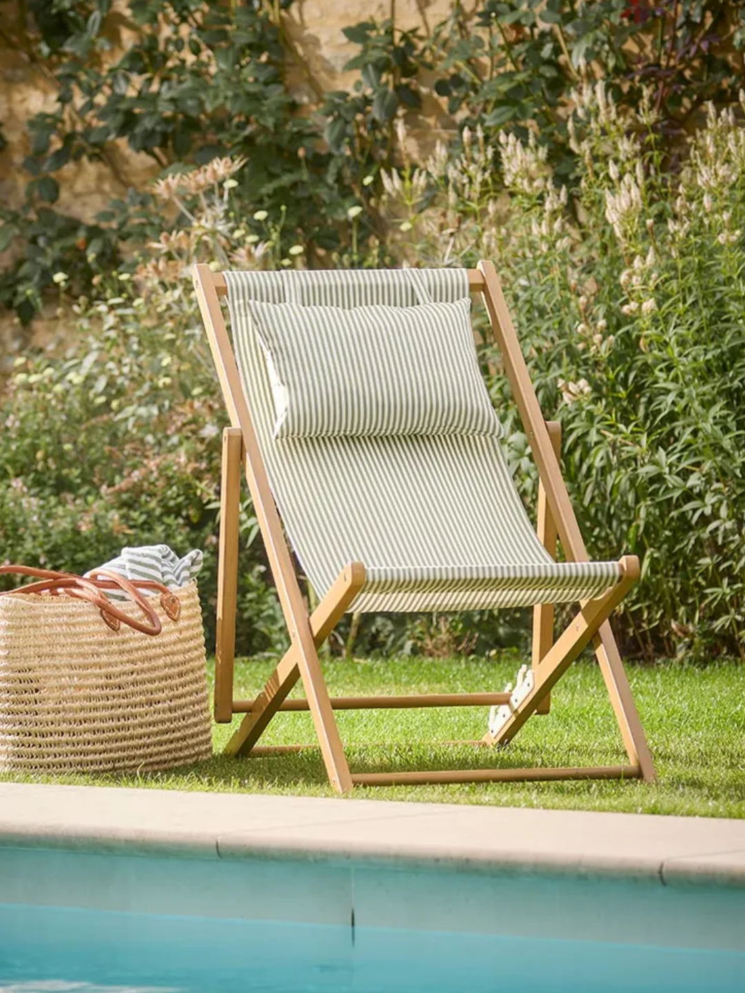 A pin-stripe deck chair by a pool