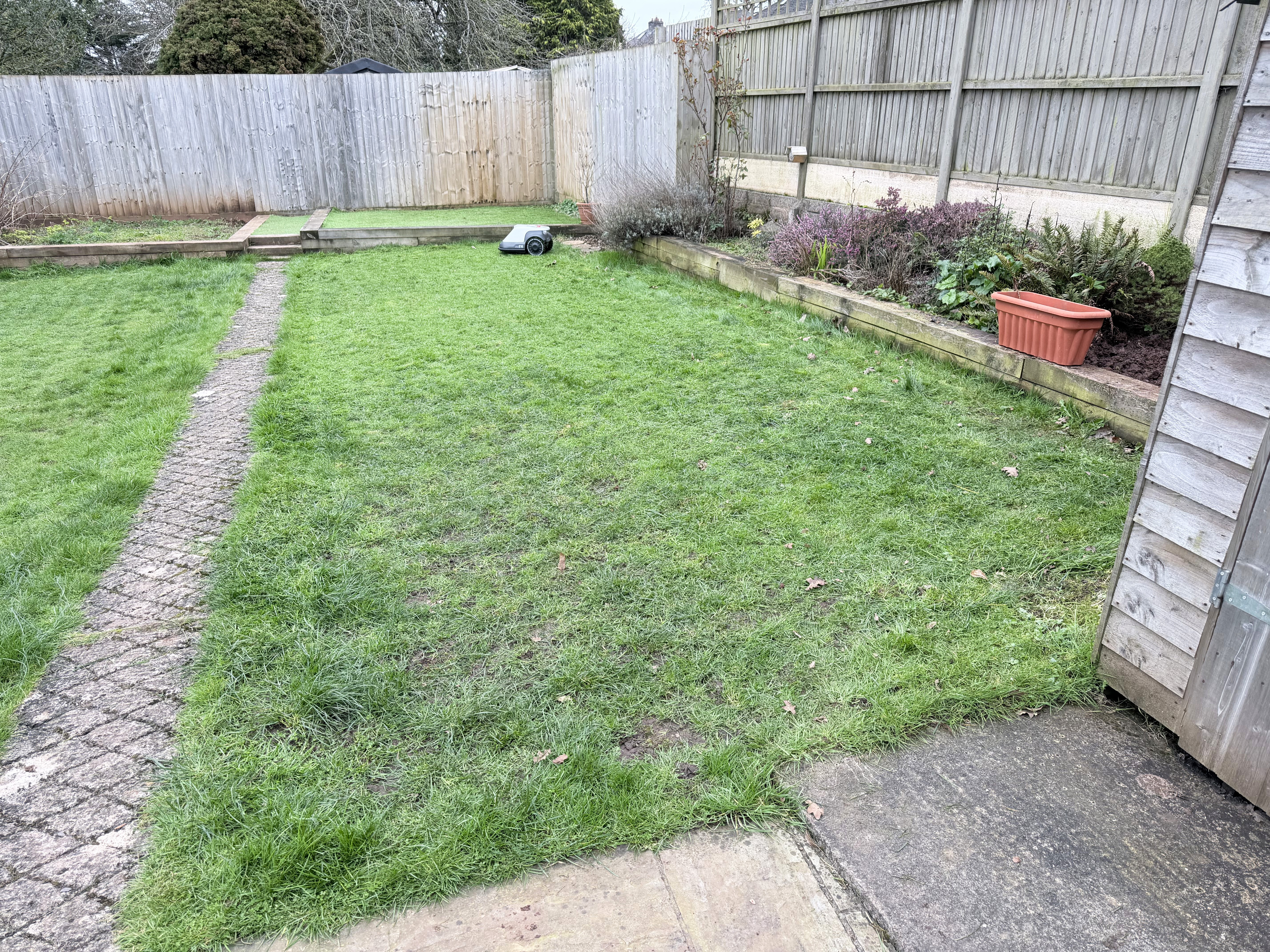 A photo showing the Eufy E15 trimming a lawn.