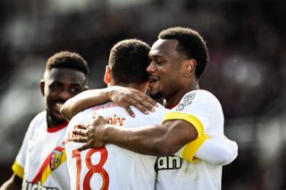 Lens' Lois Openda celebrates a goal against Clermont Foot with team-mate Alexis Claude-Maurice in March 2023.