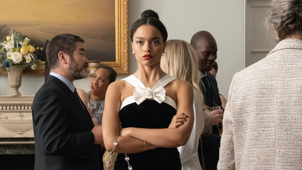 Whitney Peak standing with her arms crossed on Gossip Girl.