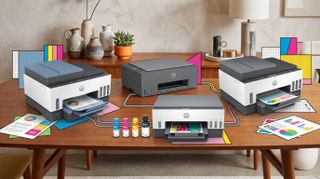A selection of HP Smart Tank printers on a table in a brightly lit home