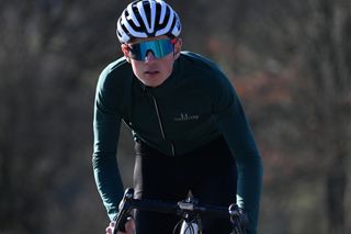 Image shows a cyclist wearing sunglasses.