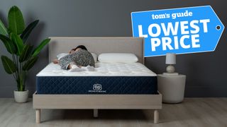 Sleep editor lying on a Brooklyn Bedding mattress, with Lowest Price graphic overlaid