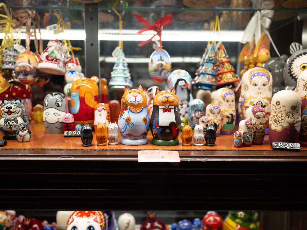 Toys displayed in a store window in Prague lit up at night