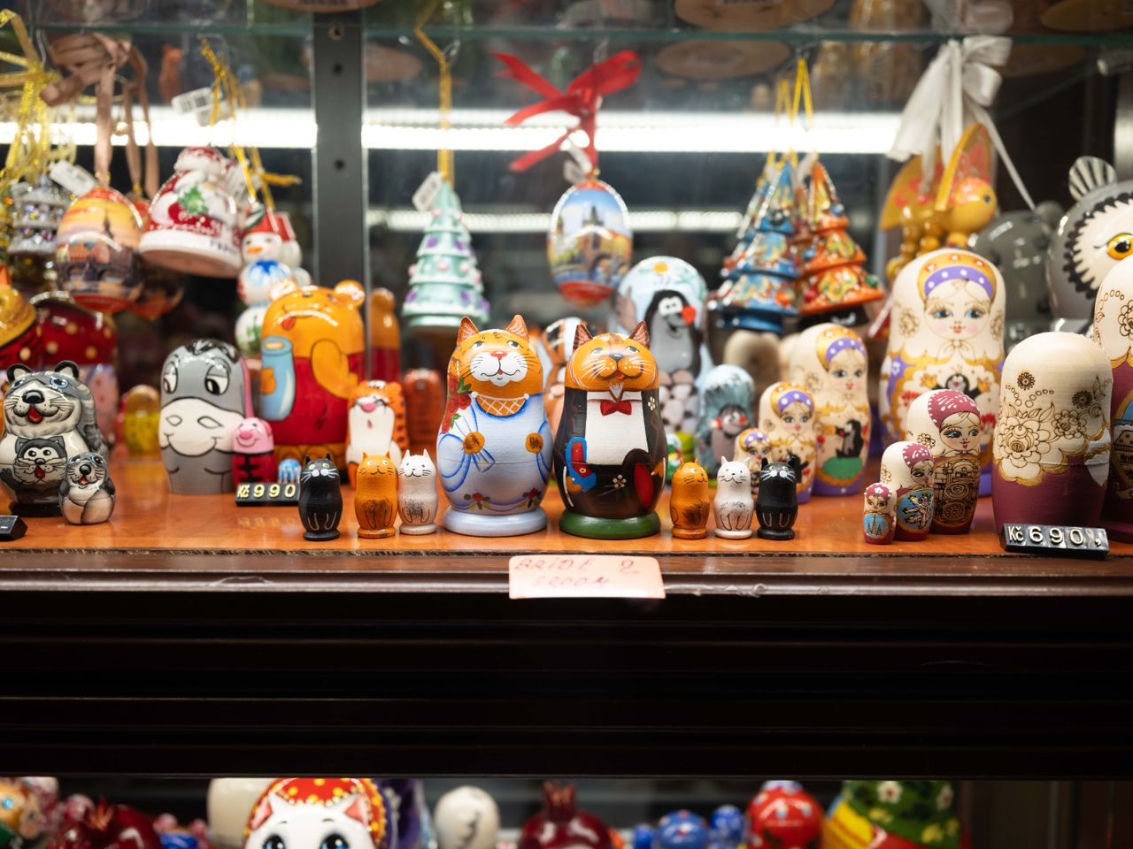 Toys displayed in a store window in Prague lit up at night