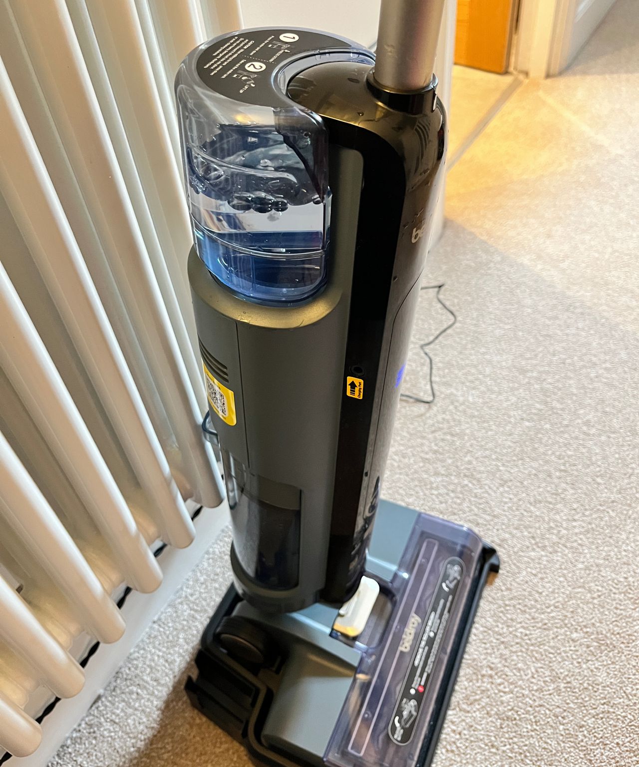 water bubbling in clean water container of floor cleaner during self-cleaning process