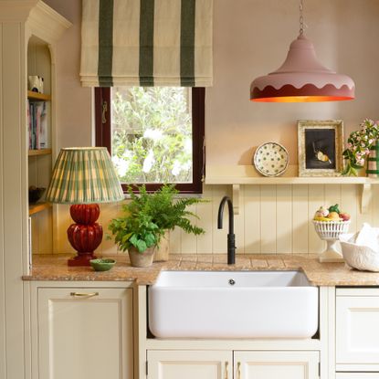 kitchen with lamp and belfast sink and striped blind and pink lamp shade