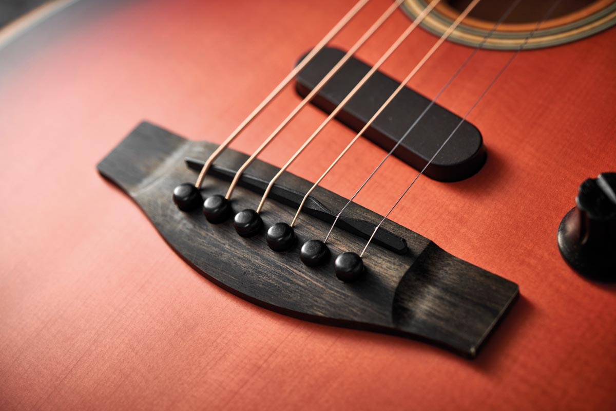 The acoustic-style pin bridge of Fender’s Acoustasonic Strat houses one of three onboard pickups.