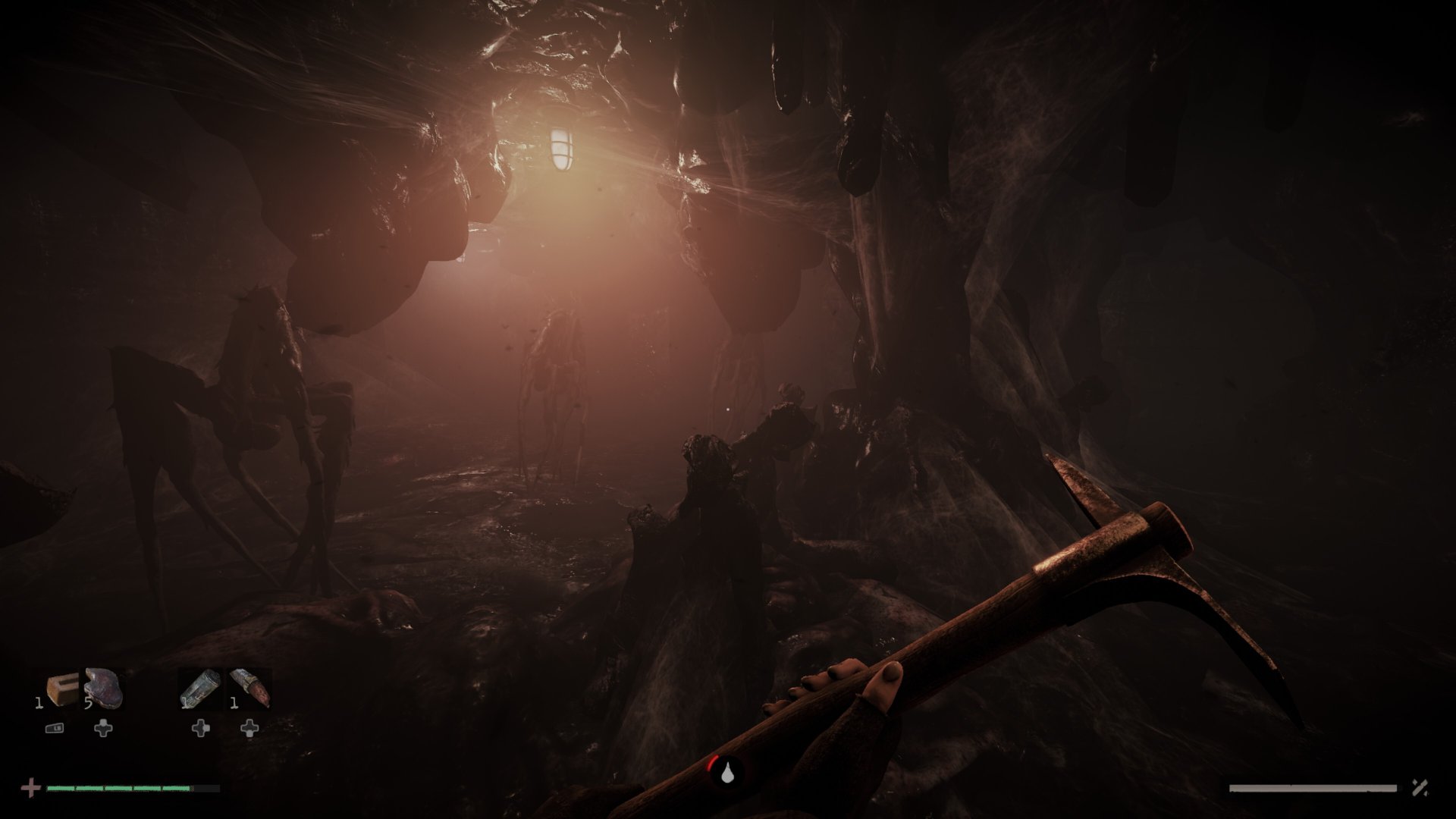 Total Chaos screenshot showing an ominous spider creature standing in dark dank cave before the protagonist who wields a pickaxe